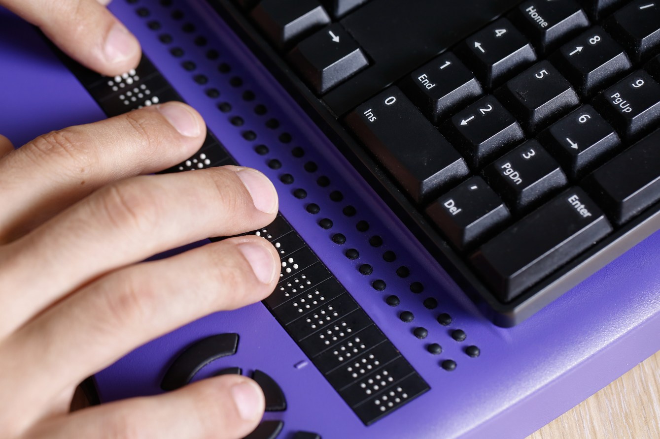 Hands typing on a Braille keyboard Hands typing on a Braille keyboard